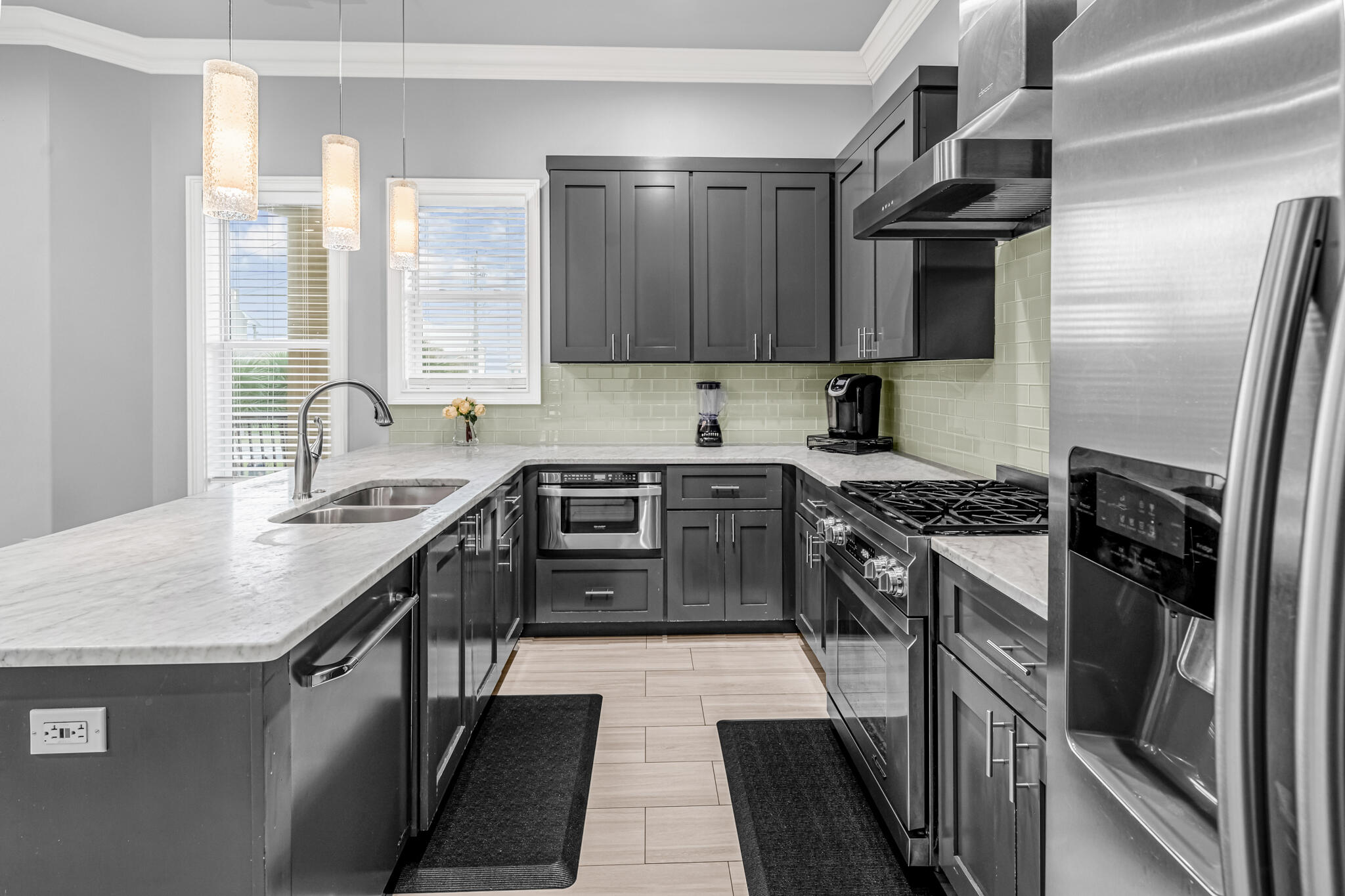 5732 West County Highway 30A Santa Rosa Beach, FL 32459 - Photo 26 of 43 a kitchen with stainless steel appliances granite countertop a sink stove and refrigerator