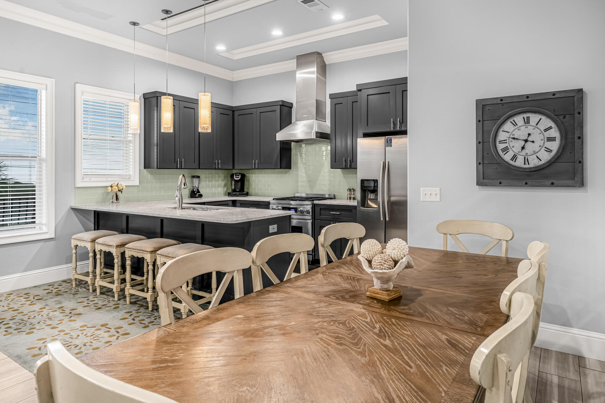 5732 West County Highway 30A Santa Rosa Beach, FL 32459 - Photo 29 of 43 a kitchen with stainless steel appliances granite countertop a dining table chairs and a refrigerator