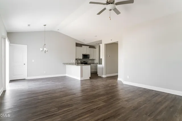 a view of kitchen with wooden floor electronic appliances and window