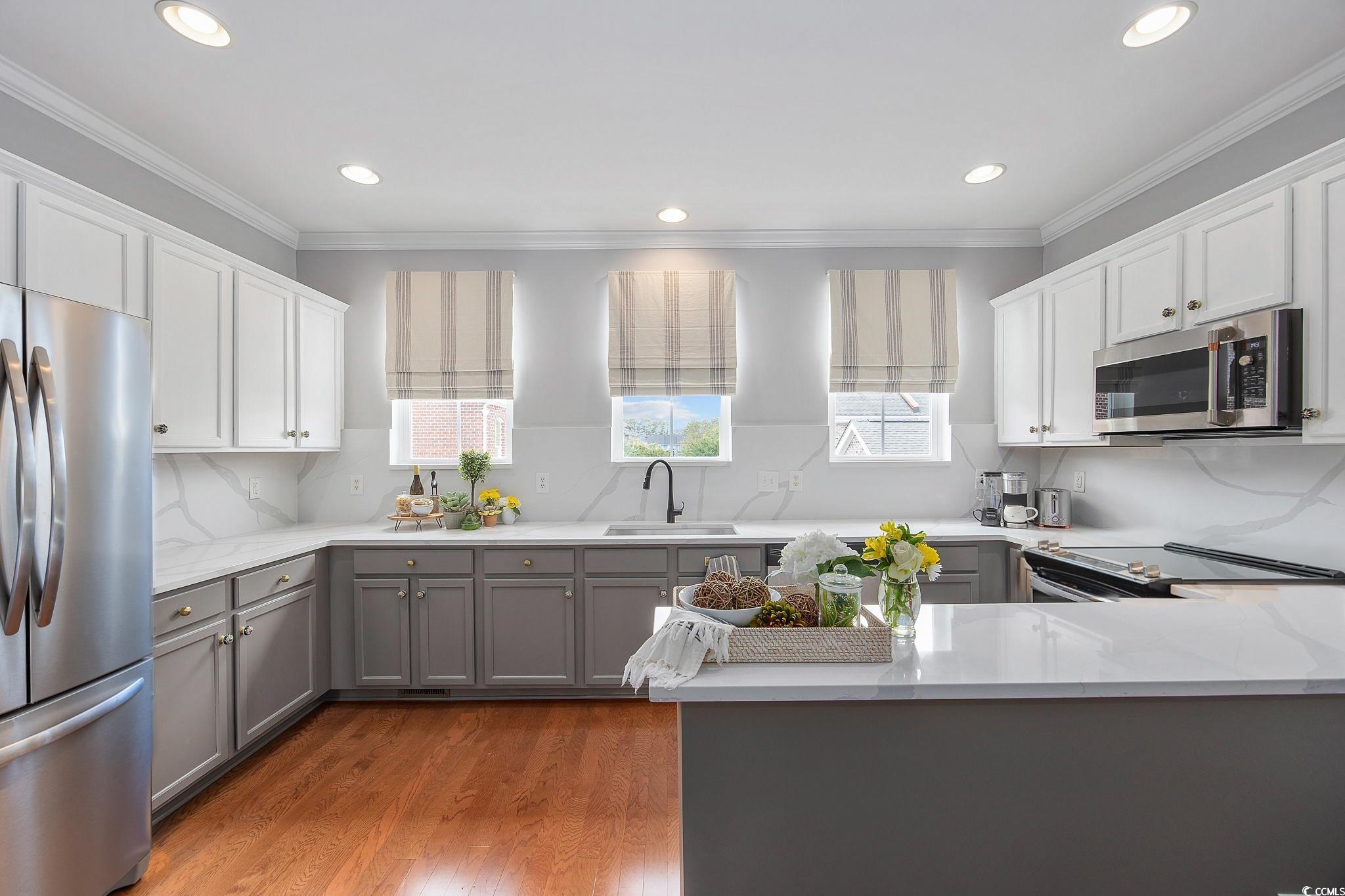 751 Murray Avenue, Unit 751 Myrtle Beach, SC 29577 - Photo 10 of 34 Kitchen with gray cabinets, plenty of natural ligh