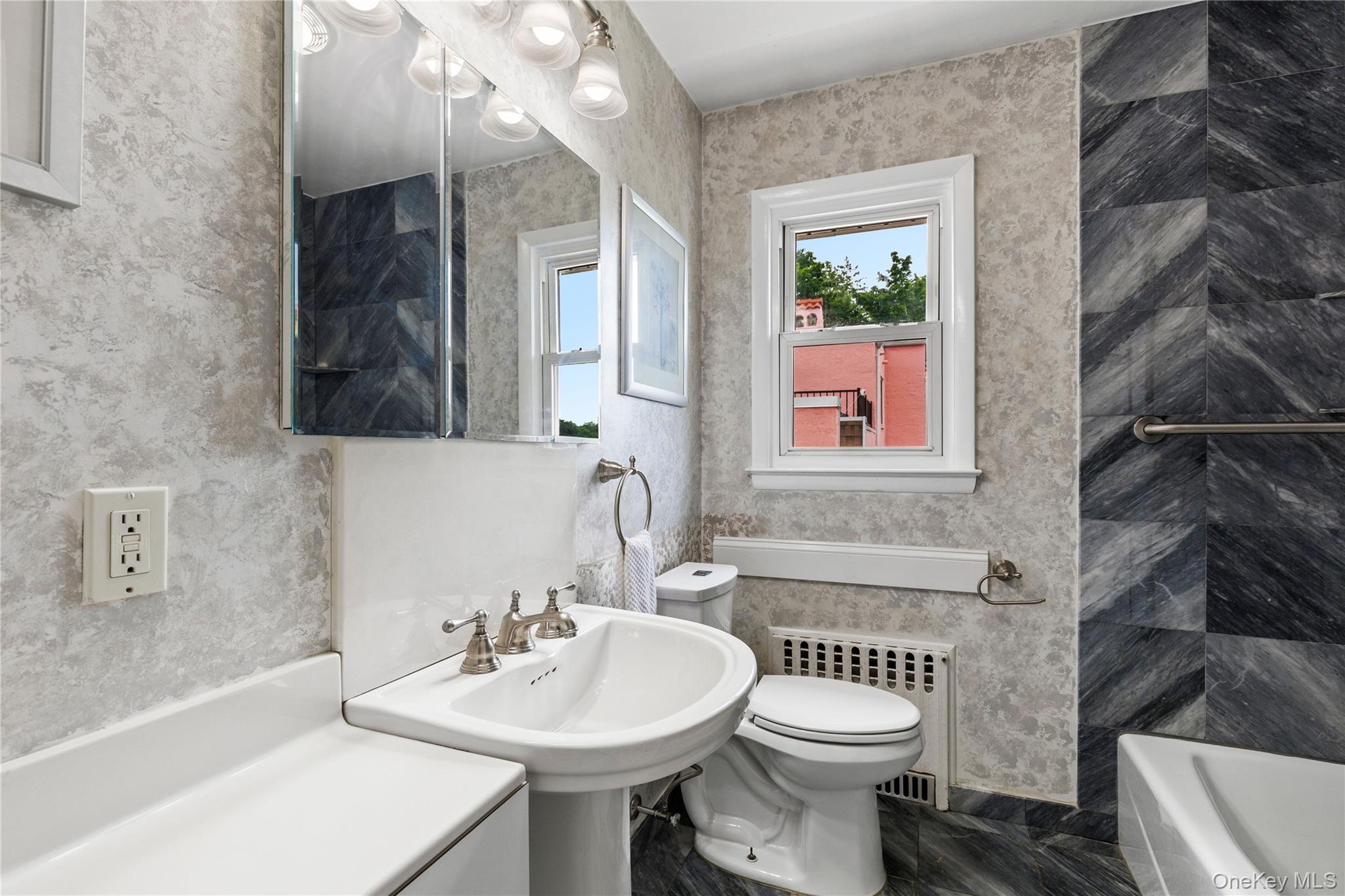 46 Mathews Street Harrison, NY 10528 - Photo 15 of 30 a bathroom with a sink a toilet and a mirror