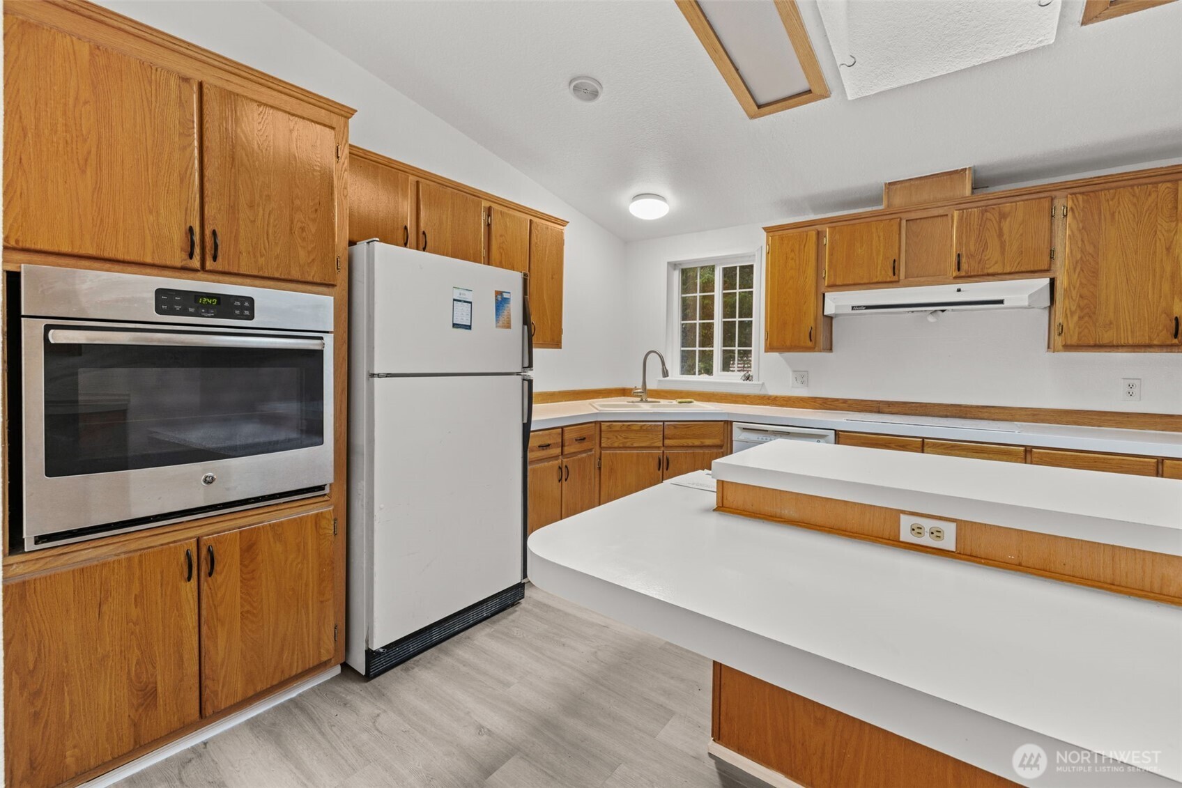 35952 Stackpole Road Ocean Park, WA 98640 - Photo 19 of 40 a kitchen with a refrigerator sink and cabinets
