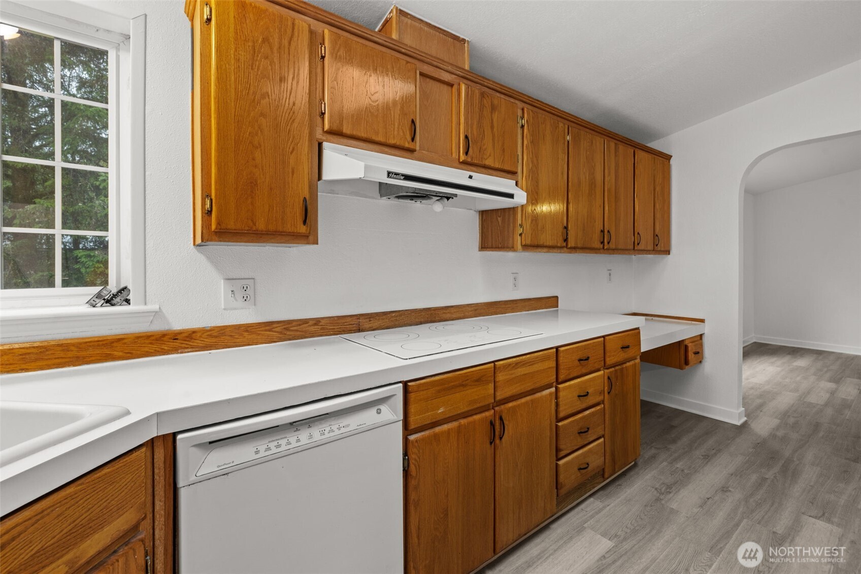 35952 Stackpole Road Ocean Park, WA 98640 - Photo 21 of 40 a kitchen with stainless steel appliances granite countertop a sink a stove and cabinets with wooden floor