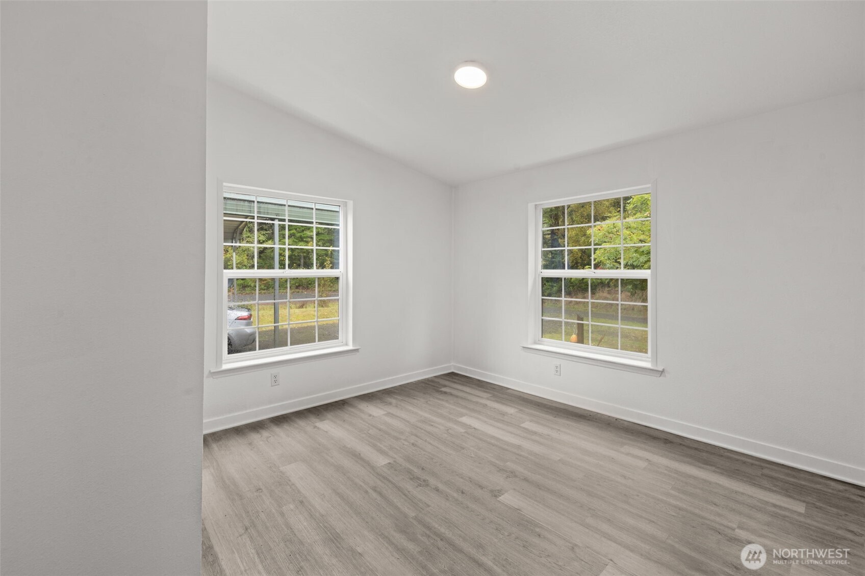 35952 Stackpole Road Ocean Park, WA 98640 - Photo 27 of 40 an empty room with wooden floor and windows