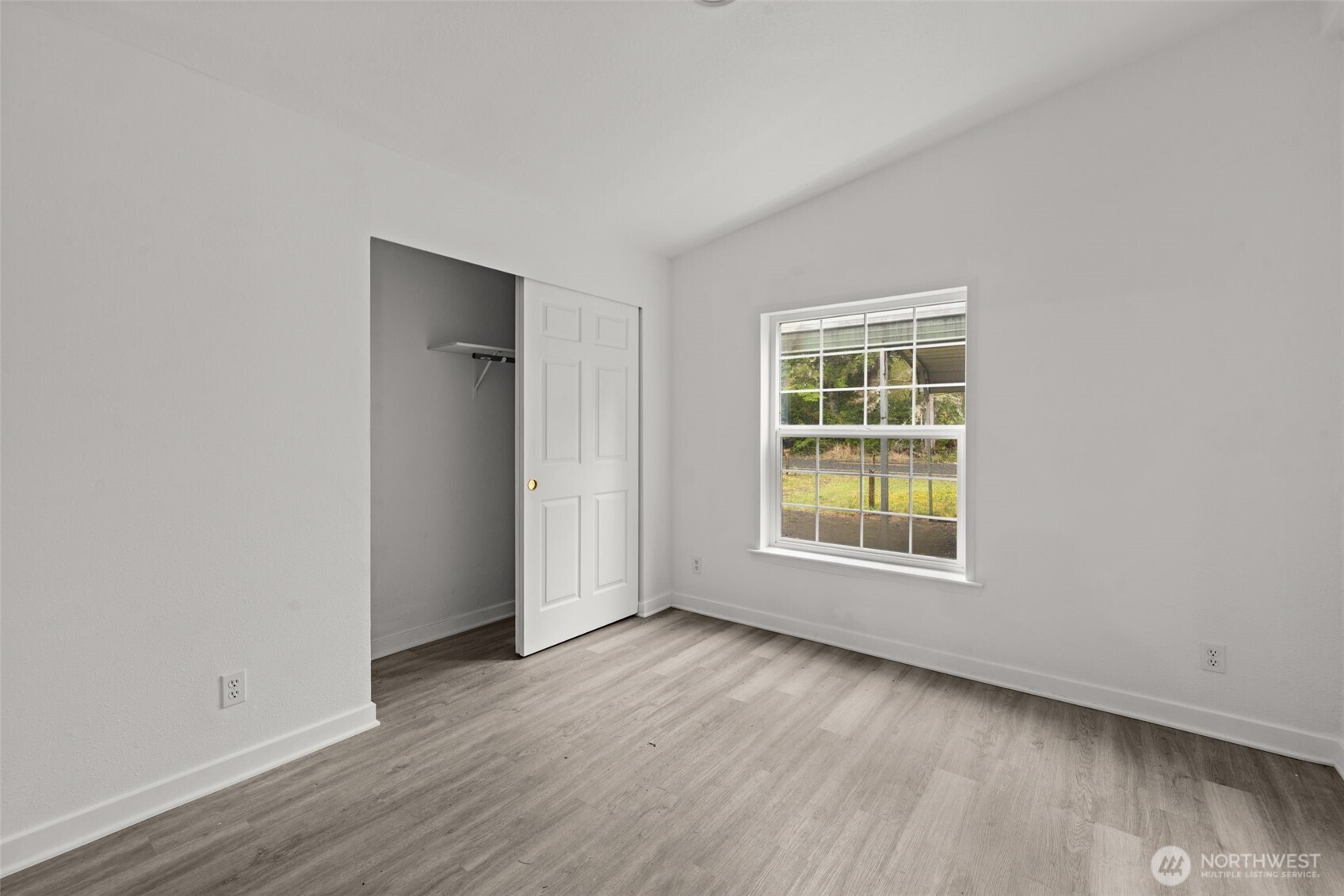35952 Stackpole Road Ocean Park, WA 98640 - Photo 31 of 40 an empty room with wooden floor and windows