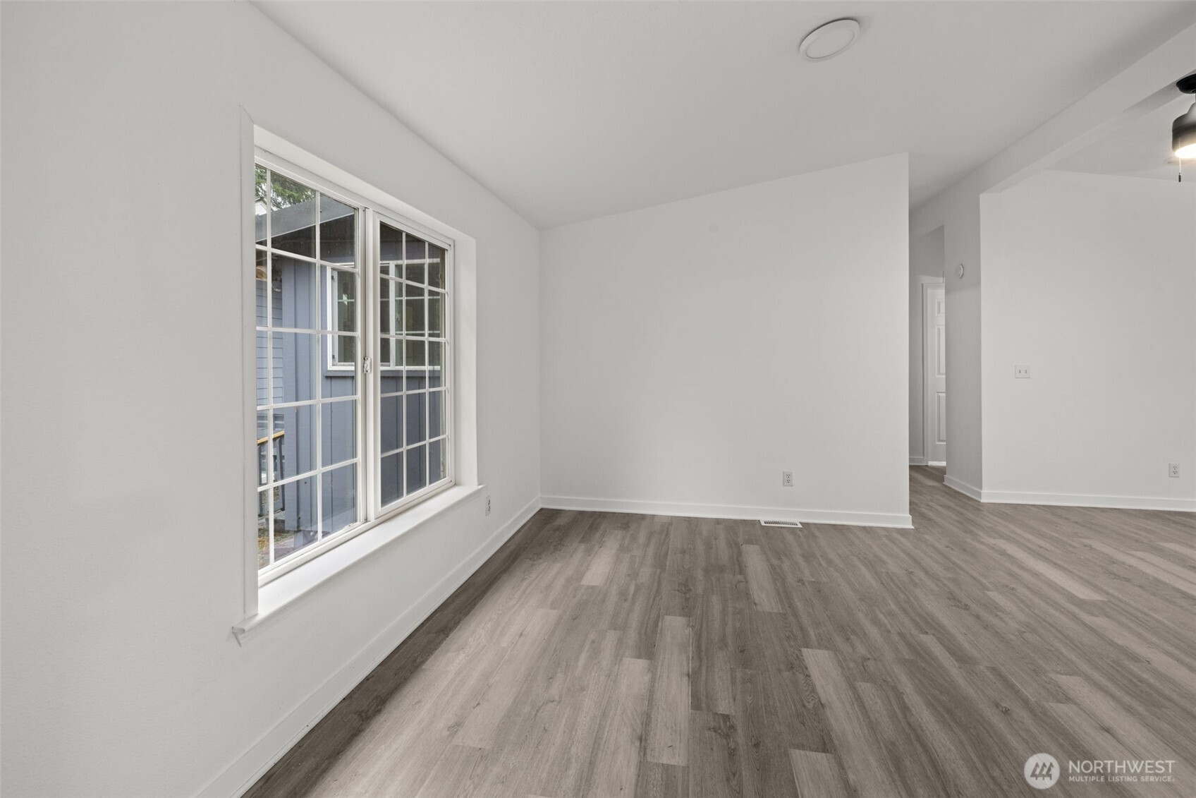 35952 Stackpole Road Ocean Park, WA 98640 - Photo 4 of 40 an empty room with wooden floor and windows