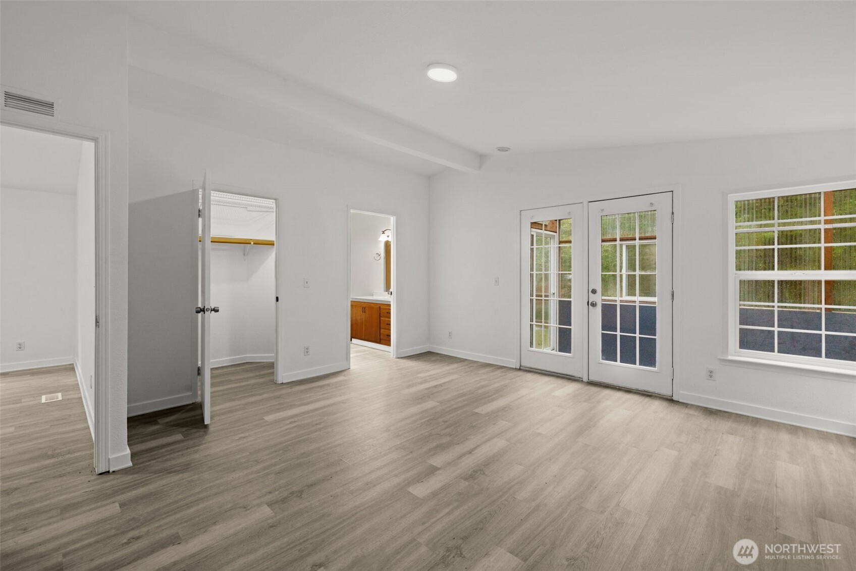 35952 Stackpole Road Ocean Park, WA 98640 - Photo 9 of 40 an empty room with wooden floor and windows