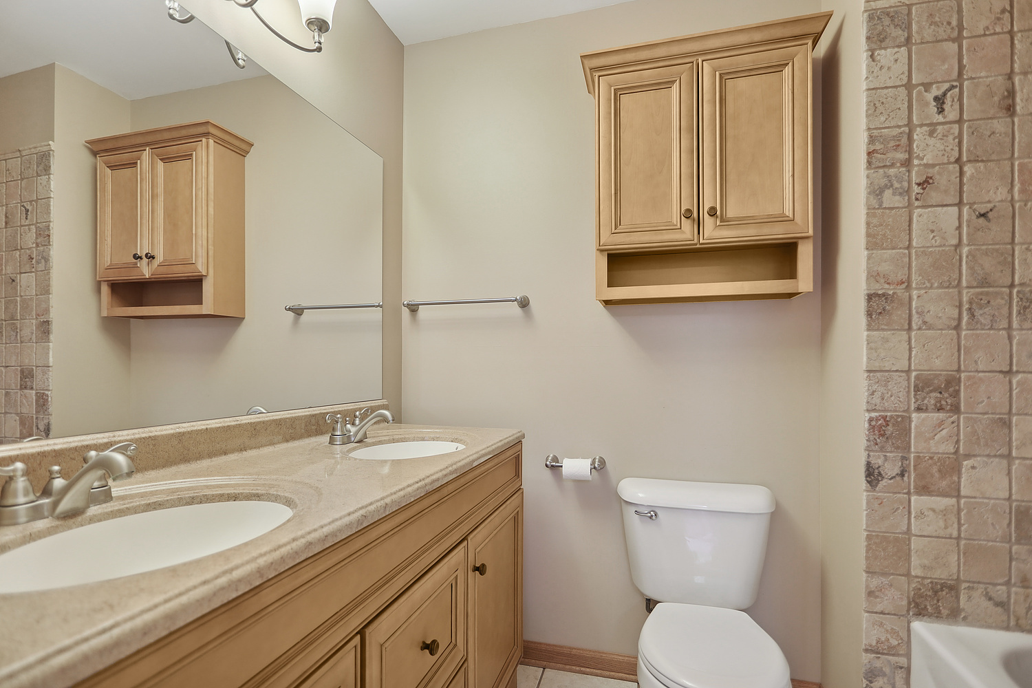 516 Whelan Street Lockport, IL 60441 - Photo 17 of 27 a bathroom with a granite countertop toilet a sink and a mirror