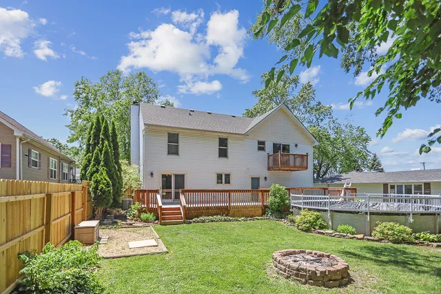 a view of a house with a yard and sitting area