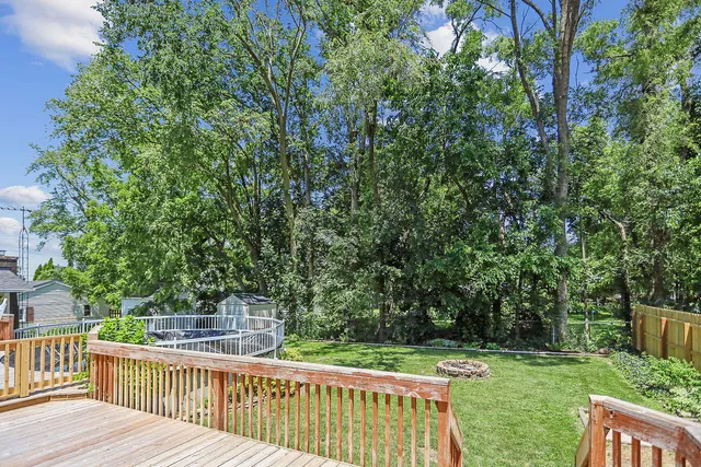 a view of a wooden deck and backyard