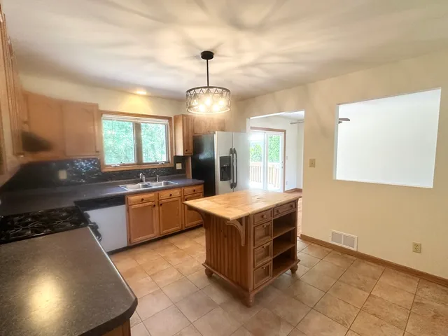 a kitchen with a stove a sink and a refrigerator