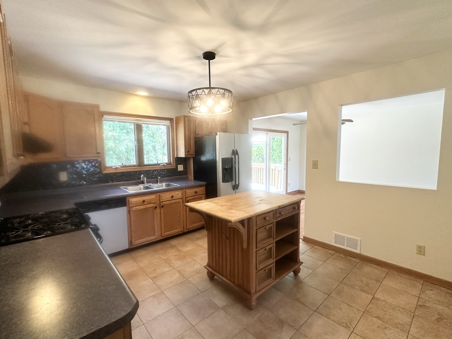 516 Whelan Street Lockport, IL 60441 - Photo 5 of 27 a kitchen with a stove a sink and a refrigerator