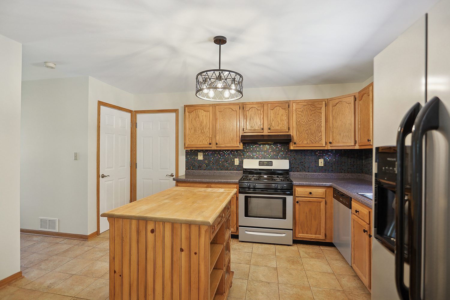516 Whelan Street Lockport, IL 60441 - Photo 6 of 27 a kitchen with stainless steel appliances granite countertop a stove sink and refrigerator
