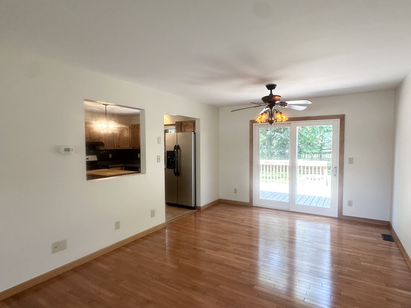 516 Whelan Street Lockport, IL 60441 - Photo 7 of 27 a view of an empty room with window and wooden floor