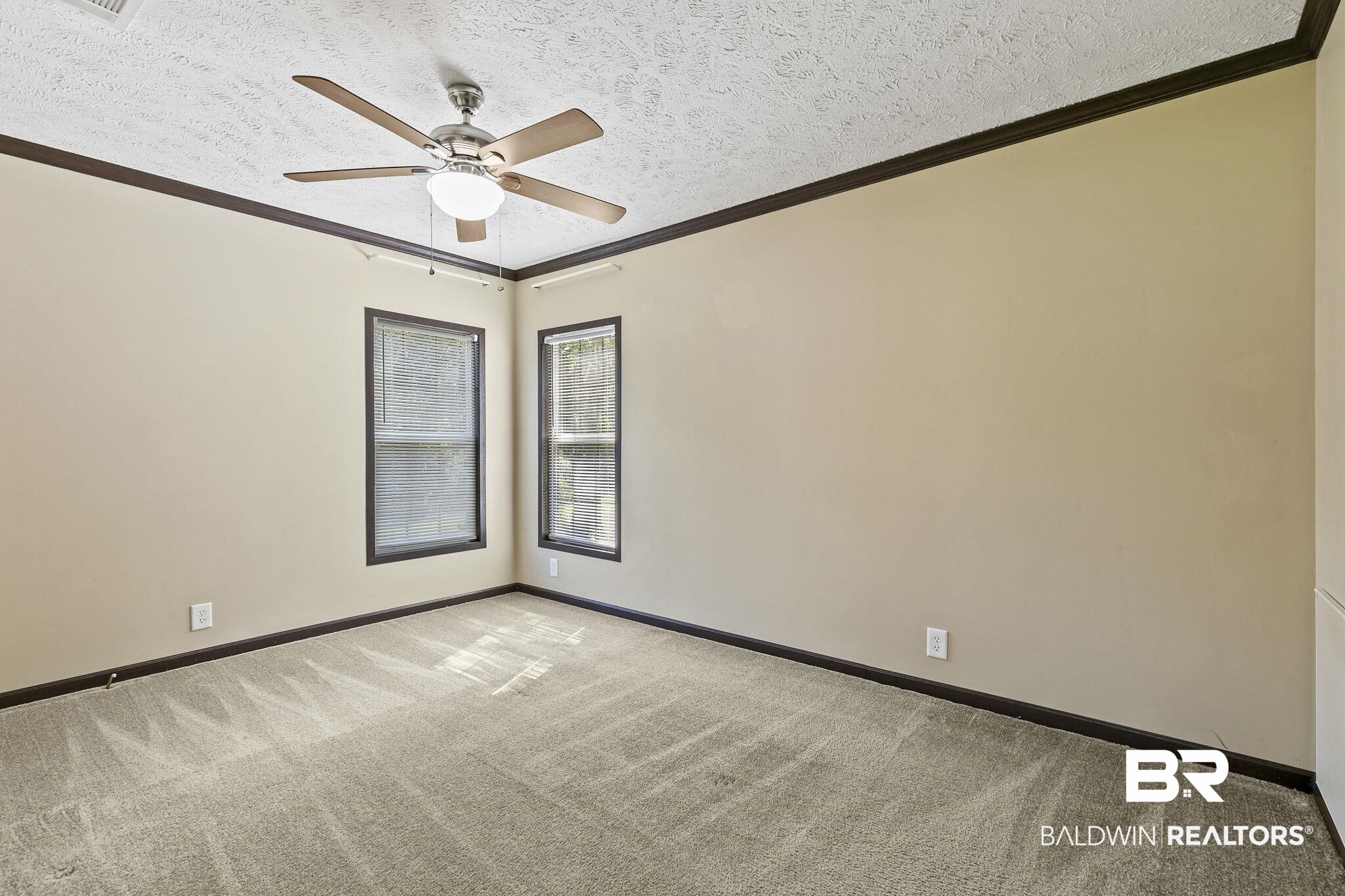 35641 County Road 39 Stapleton, AL 36578 - Photo 24 of 46 Carpeted spare room featuring a textured ceiling, ornamental molding, and ceiling fan