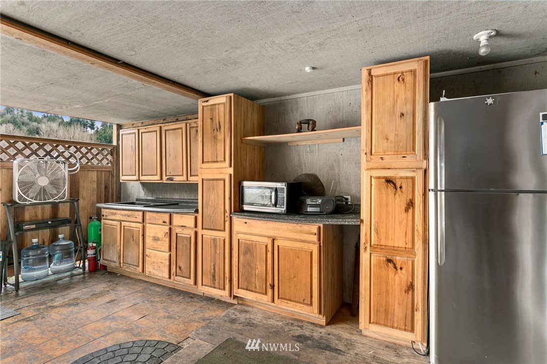21234 Redmond-Fall City Road Northeast Redmond, WA 98053 - Photo 12 of 18 a kitchen with stainless steel appliances a refrigerator sink and cabinets