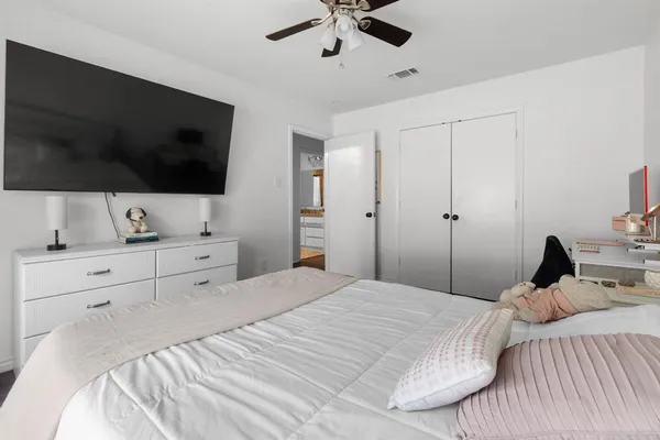 a bedroom with a bed and a flat screen tv