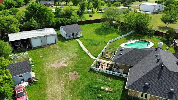 an aerial view of a house with a garden and yard
