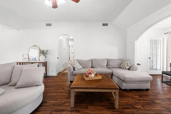 a living room with furniture and wooden floor