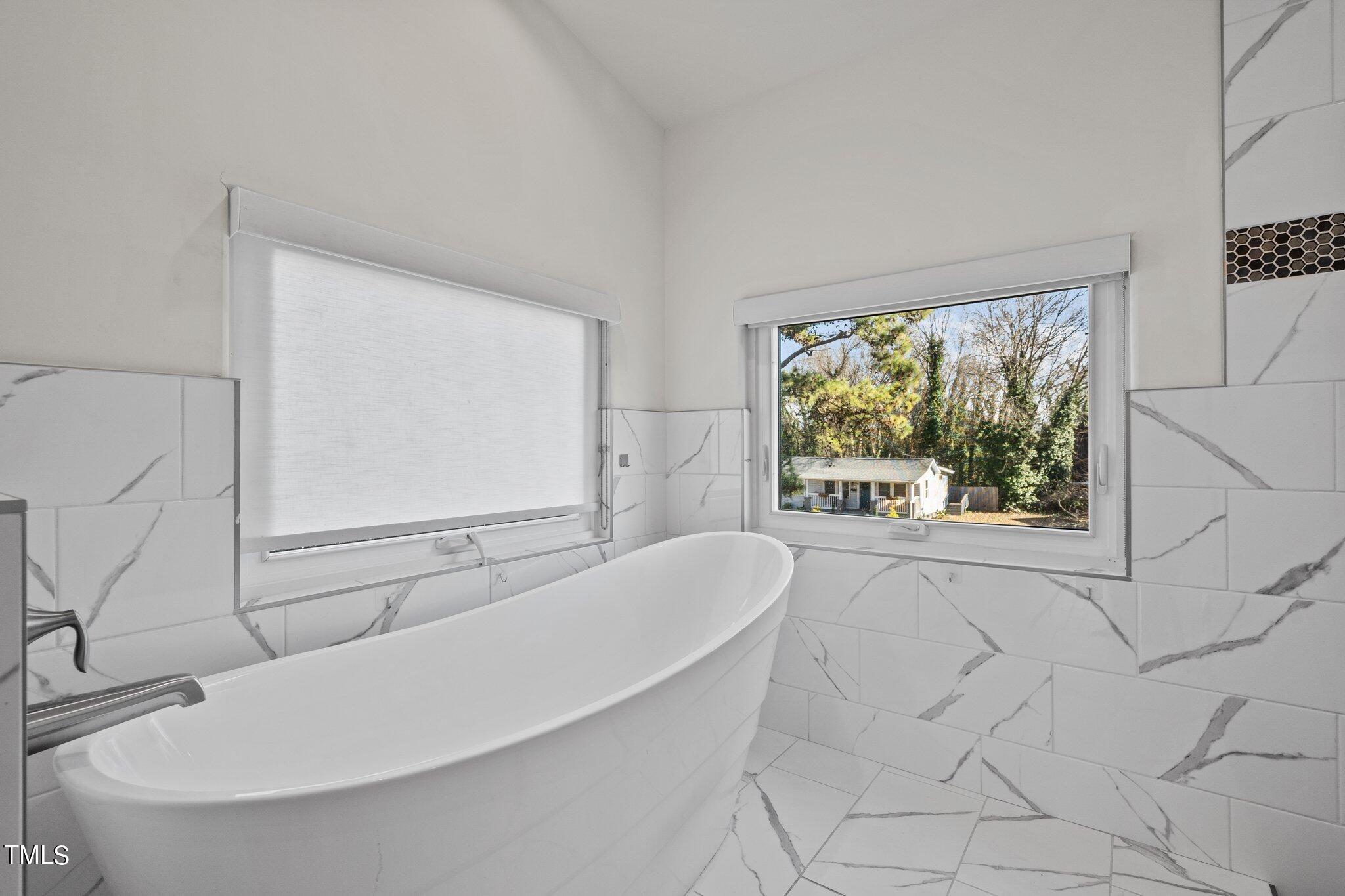 1427 East Lane Street Raleigh, NC 27610 - Photo 23 of 53 a bathroom with a bathtub and window