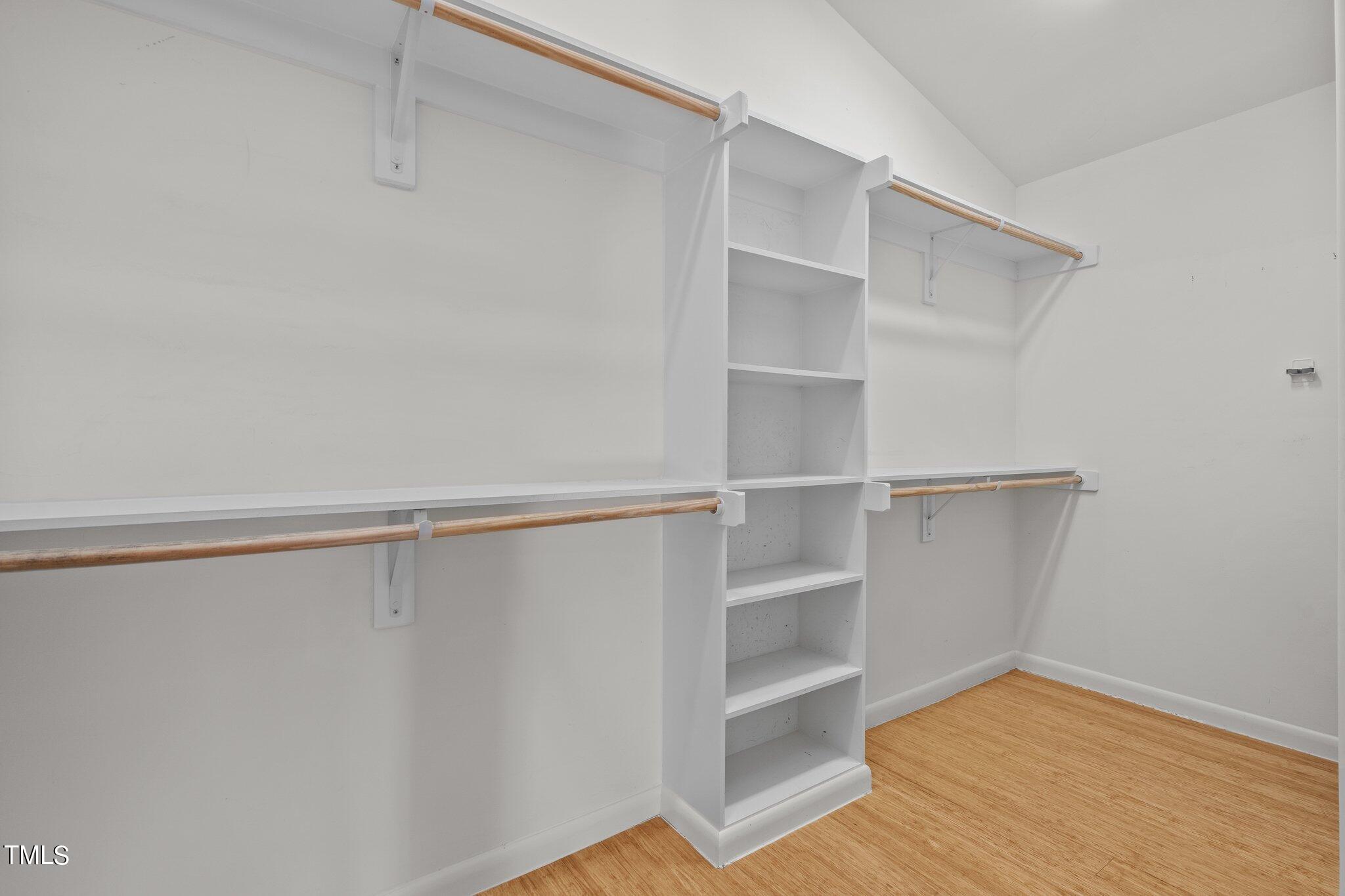 1427 East Lane Street Raleigh, NC 27610 - Photo 24 of 53 a view of walk in closet with empty racks