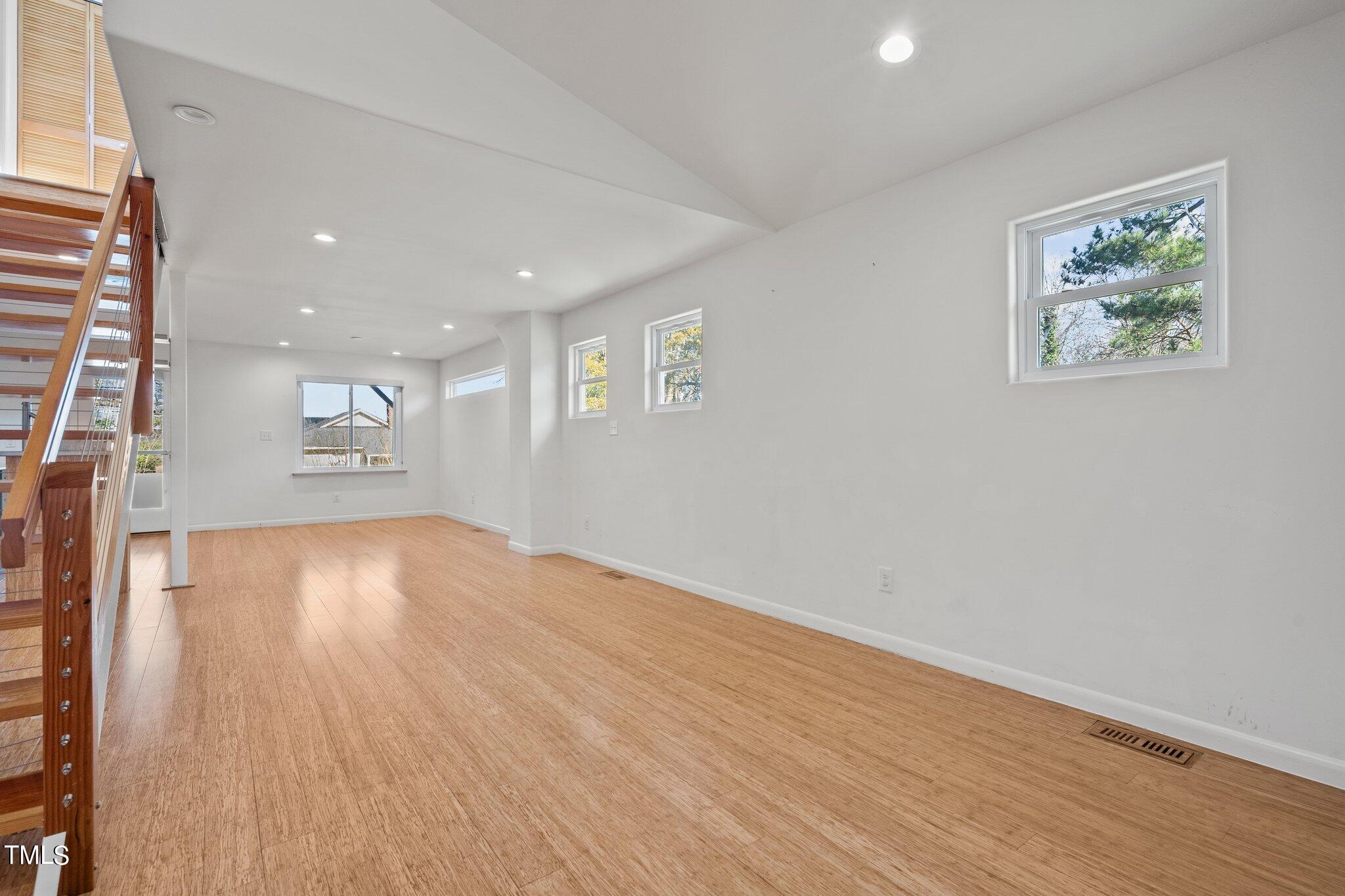 1427 East Lane Street Raleigh, NC 27610 - Photo 5 of 53 a view of an empty room with wooden floor and a window