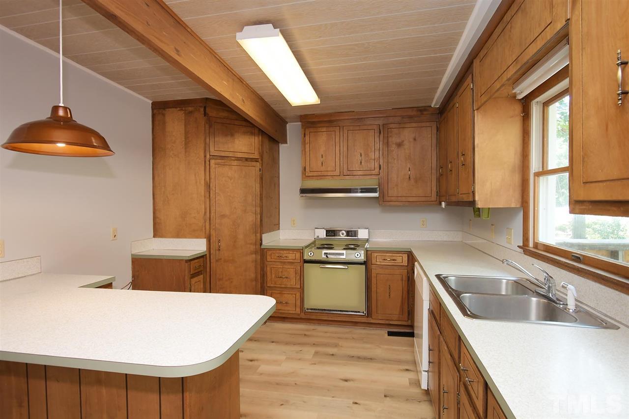 19 Learned Place Durham, NC 27705 - Photo 3 of 30 a kitchen with stainless steel appliances granite countertop a sink a stove and a refrigerator