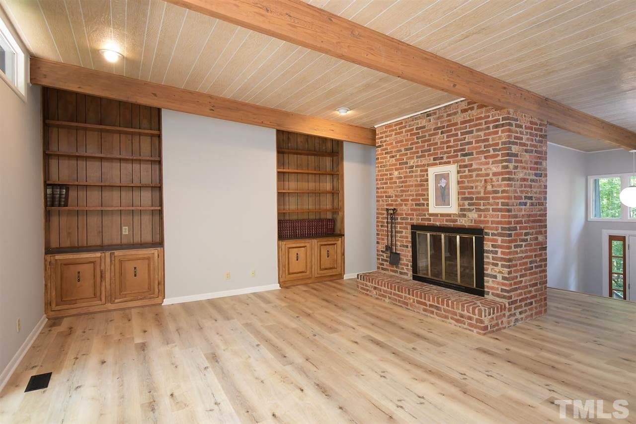 19 Learned Place Durham, NC 27705 - Photo 7 of 30 a view of a livingroom with wooden floor and a fireplace
