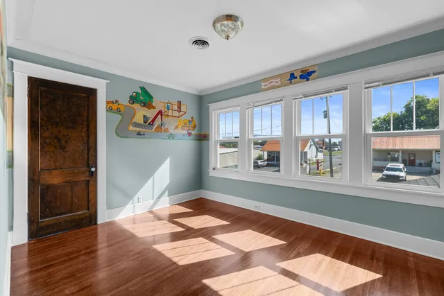 a bedroom with a bed and a painting on the wall