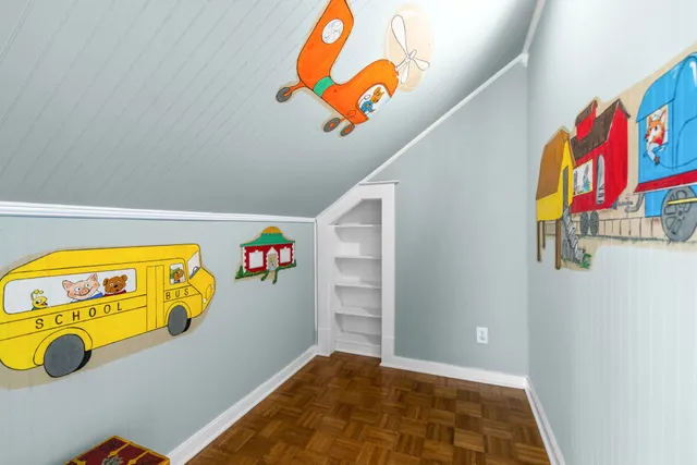 a bedroom with a large bed and a flat screen tv