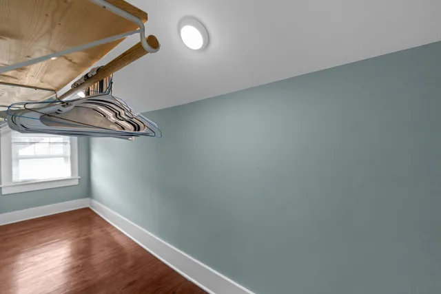 a view of an empty room and wooden floor