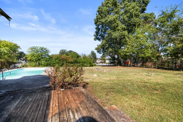 a view of a swimming pool with a yard