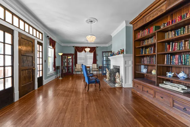 a living room with furniture fireplace and wooden floor