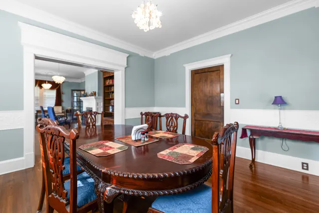 a view of a workspace with furniture and a book shelf