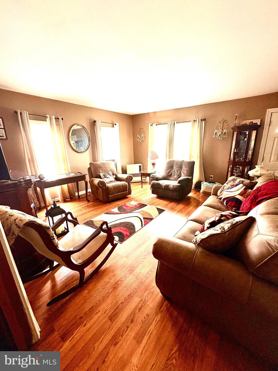 3411 Marsh Road Ewell, MD 21824 - Photo 12 of 24 a living room with furniture and a wooden floor