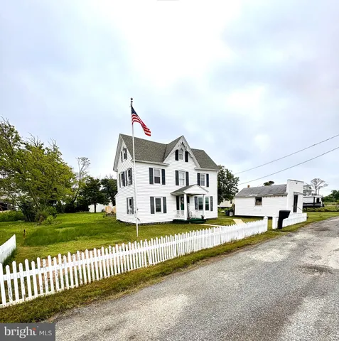 a view of a house with a big yard and large trees
