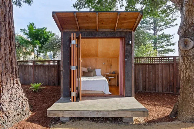 a wooden bench sitting in front of a building