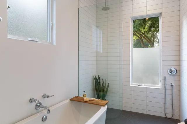 a bathroom with a tub and shower