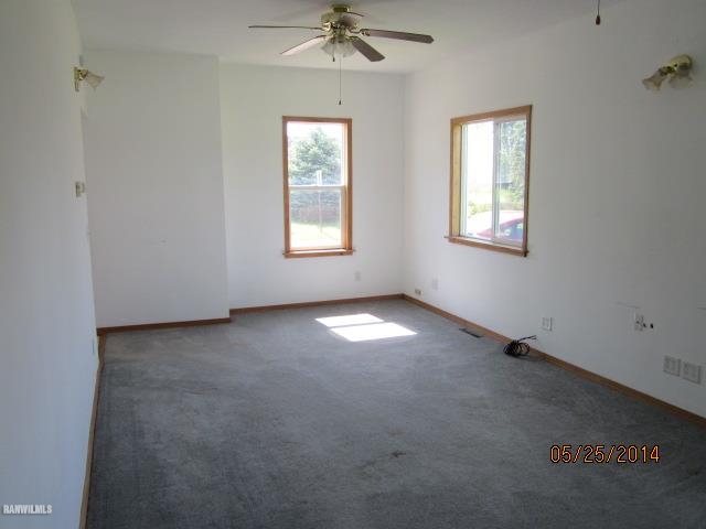 16583 Argo Fay Route Thomson, IL 61285 - Photo 3 of 18 an empty room with a window and a fan