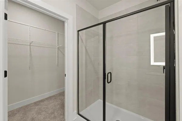 a bathroom with a glass shower door