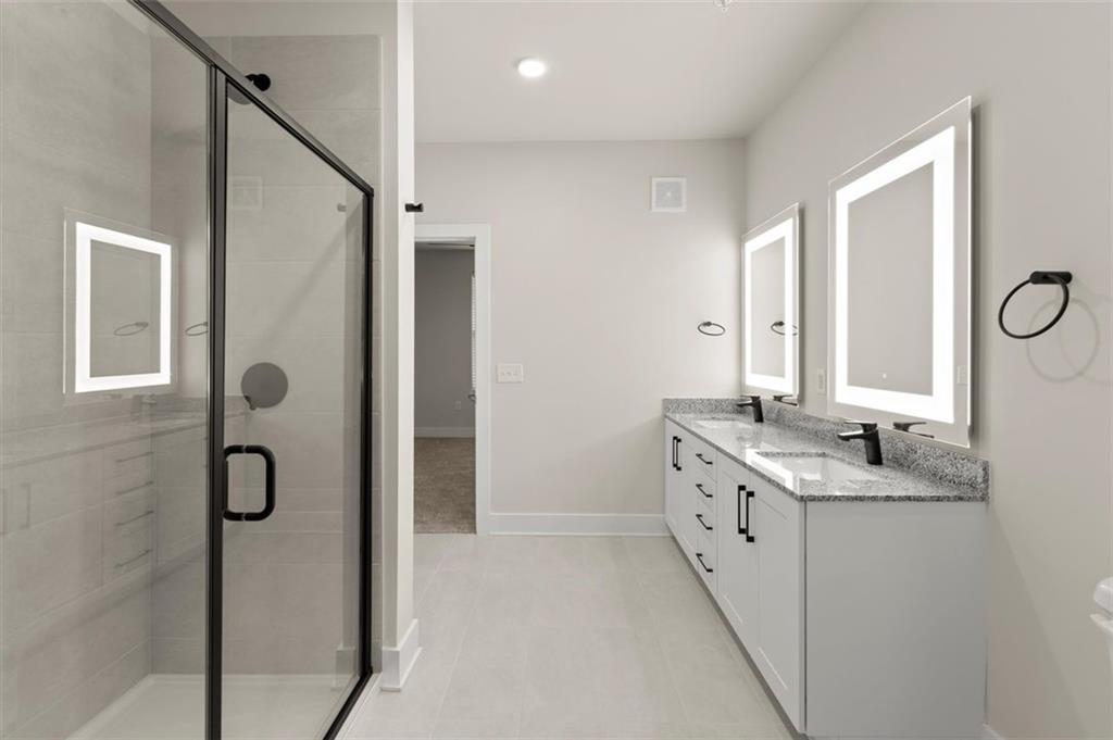 2648 Sandy Plains Road, Unit 420 Marietta, GA 30062 - Photo 24 of 37 a bathroom with a double vanity sink and mirror with shower