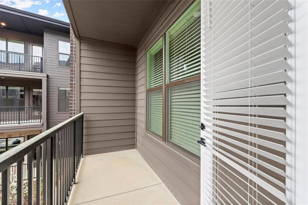 2648 Sandy Plains Road, Unit 420 Marietta, GA 30062 - Photo 25 of 37 a view of a balcony with door and outdoor space