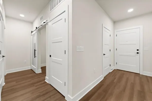 a view of hallway with wooden floor