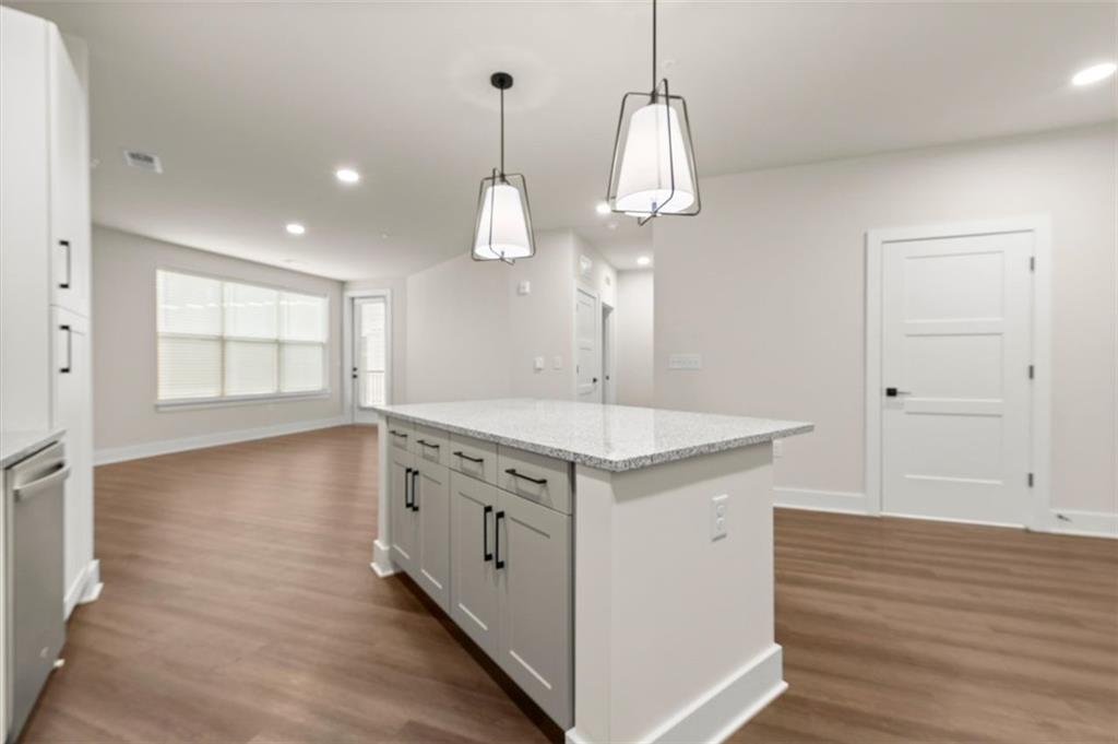 2648 Sandy Plains Road, Unit 420 Marietta, GA 30062 - Photo 5 of 37 a kitchen with stainless steel appliances granite countertop a sink a stove and a wooden floor