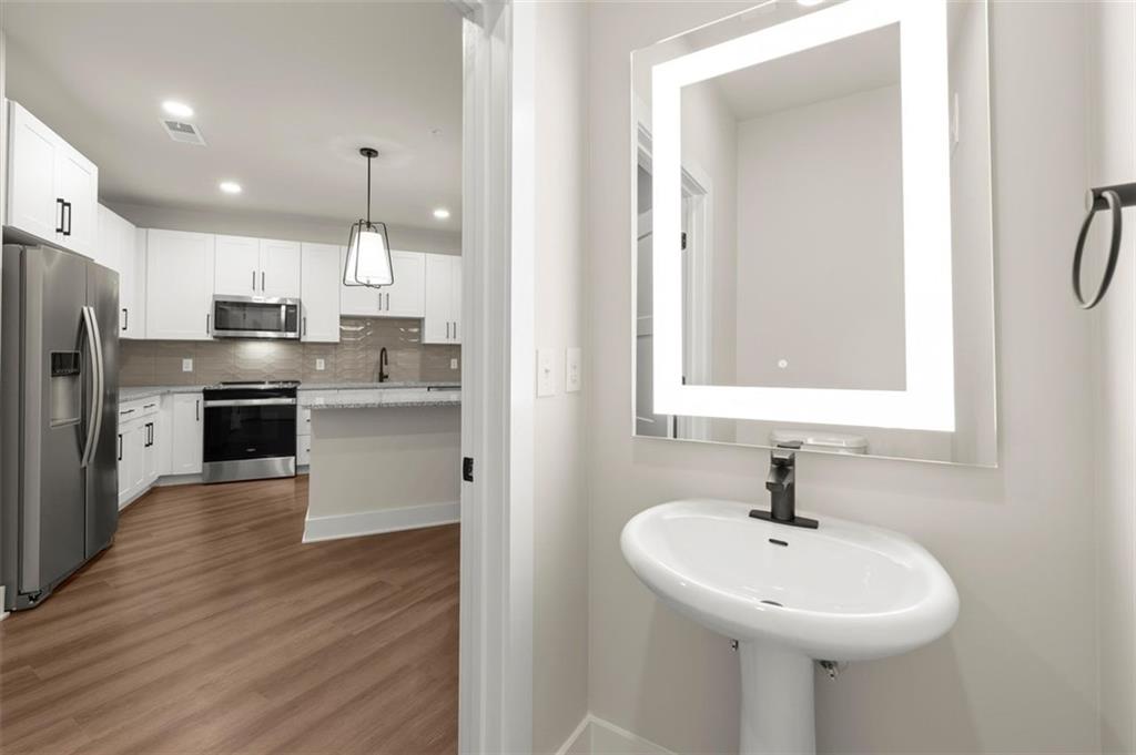 2648 Sandy Plains Road, Unit 420 Marietta, GA 30062 - Photo 8 of 37 a kitchen with a sink stainless steel appliances and white cabinets