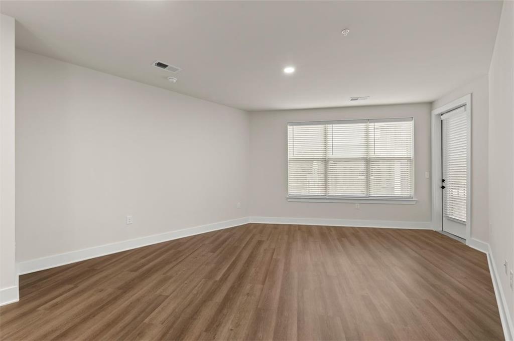 2648 Sandy Plains Road, Unit 420 Marietta, GA 30062 - Photo 10 of 37 wooden floor in an empty room with a window