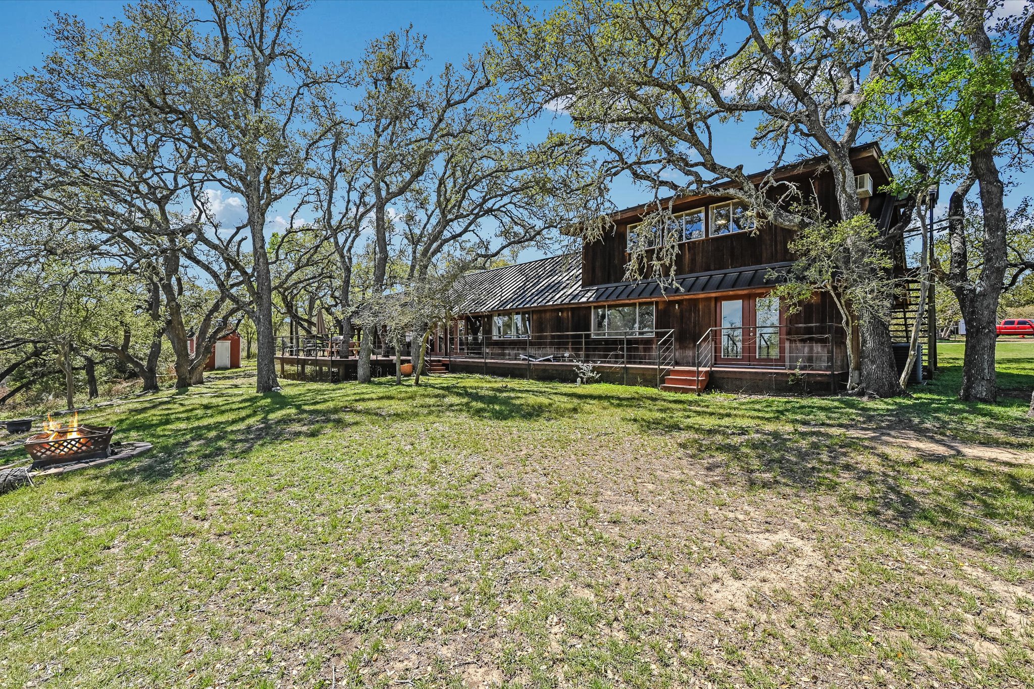 411 Whitetail Ridge Austin, TX 78737 - Photo 27 of 38 View of green lawn with a deck and a fire pit