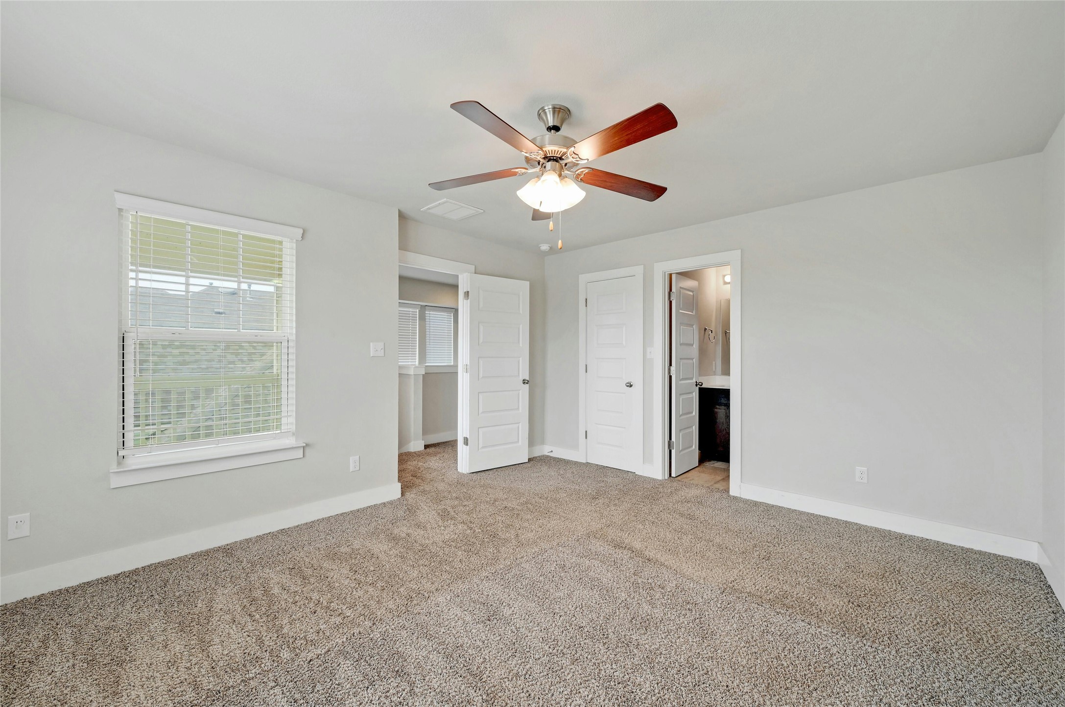 121 Switchgrass Street San Marcos, TX 78666 - Photo 22 of 33 Main bedroom with doors to hallway and bathroom.