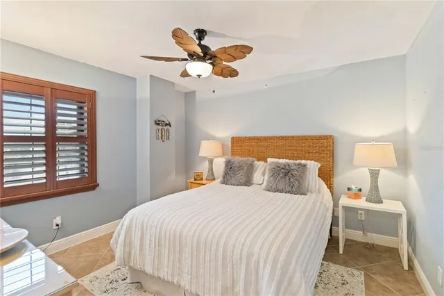 a bedroom with a bed and potted plants with the outer view