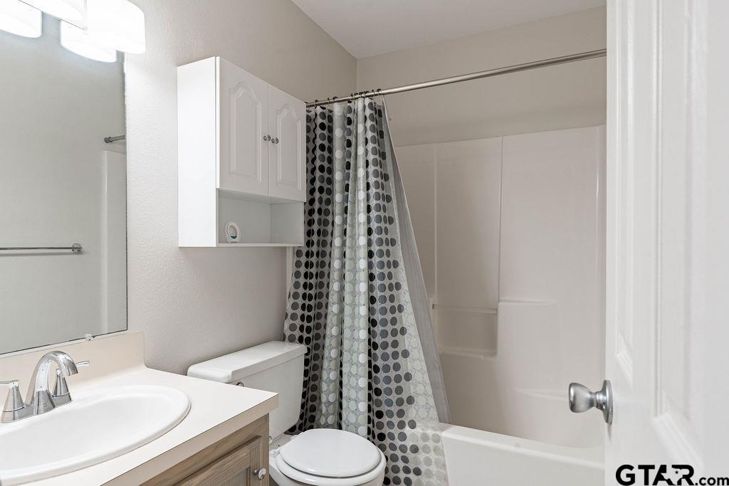 360 Anderson County Road Palestine, TX 75803 - Photo 2 of 41 a bathroom with a sink toilet and shower